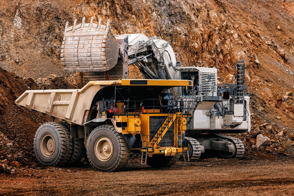 Excavator loading a haul truck in an open-pit mine
